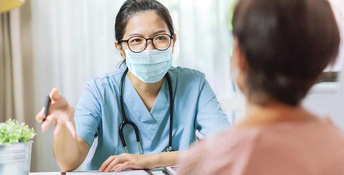 A health care professional meeting with a patient.