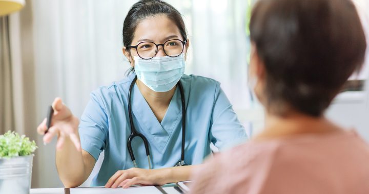 A health care professional meeting with a patient.