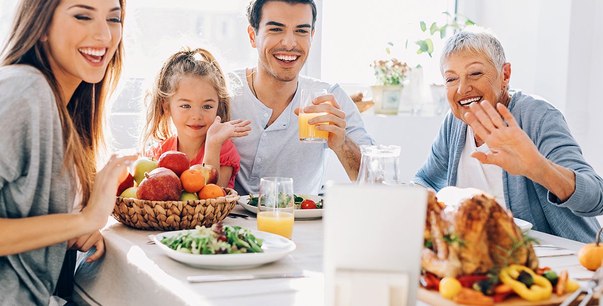 A family celebrating Thanksgiving virtually with others.