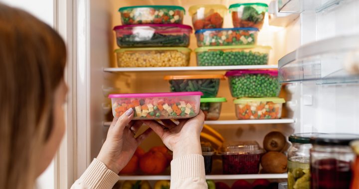 A woman meal prepping in her kitchen.,