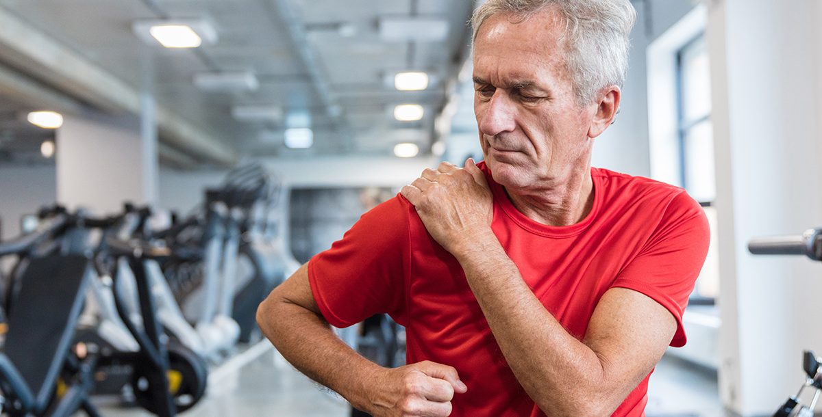 A man practicing physical therapy after total shoulder replacement surgery.