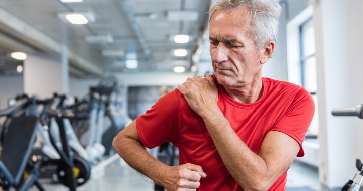 A man practicing physical therapy after total shoulder replacement surgery.