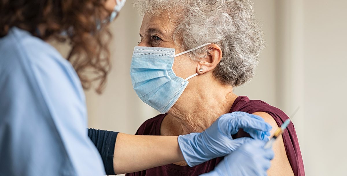 An older woman receiving her COVID-19 vaccine.