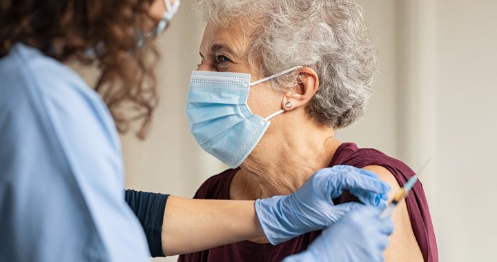 An older woman receiving her COVID-19 vaccine.