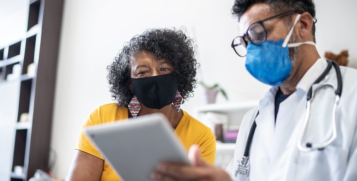 A woman meeting with her health care provider.