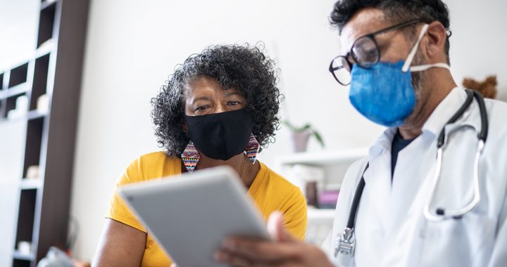 A woman meeting with her health care provider.