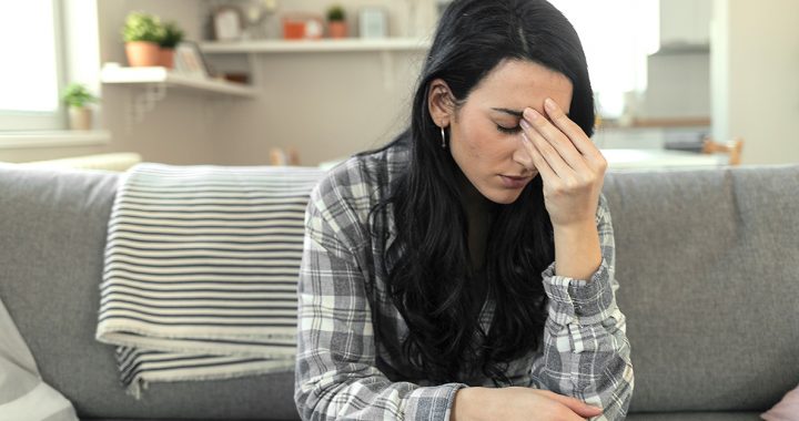 A woman experiencing COVID-19 vaccine side effects.