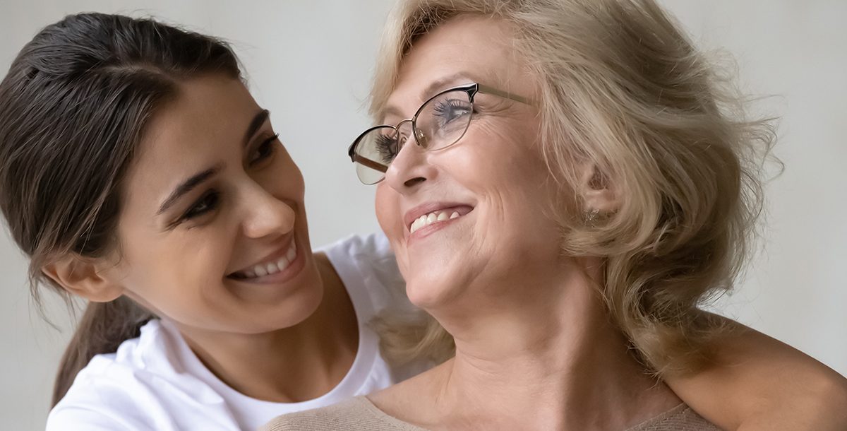 A mother and daughter embracing.