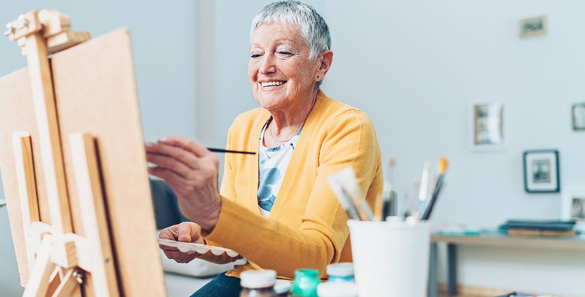 A woman enjoying painting.