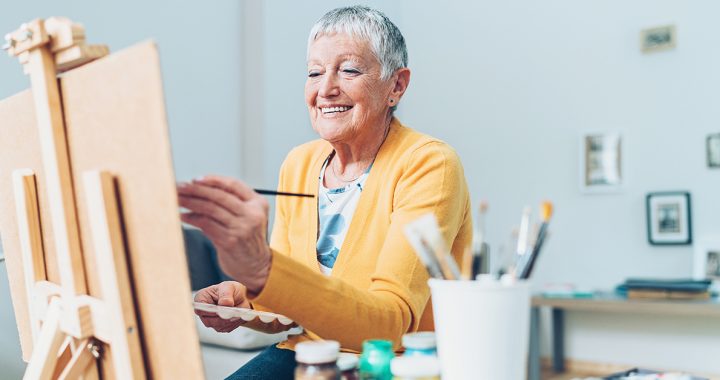 A woman enjoying painting.