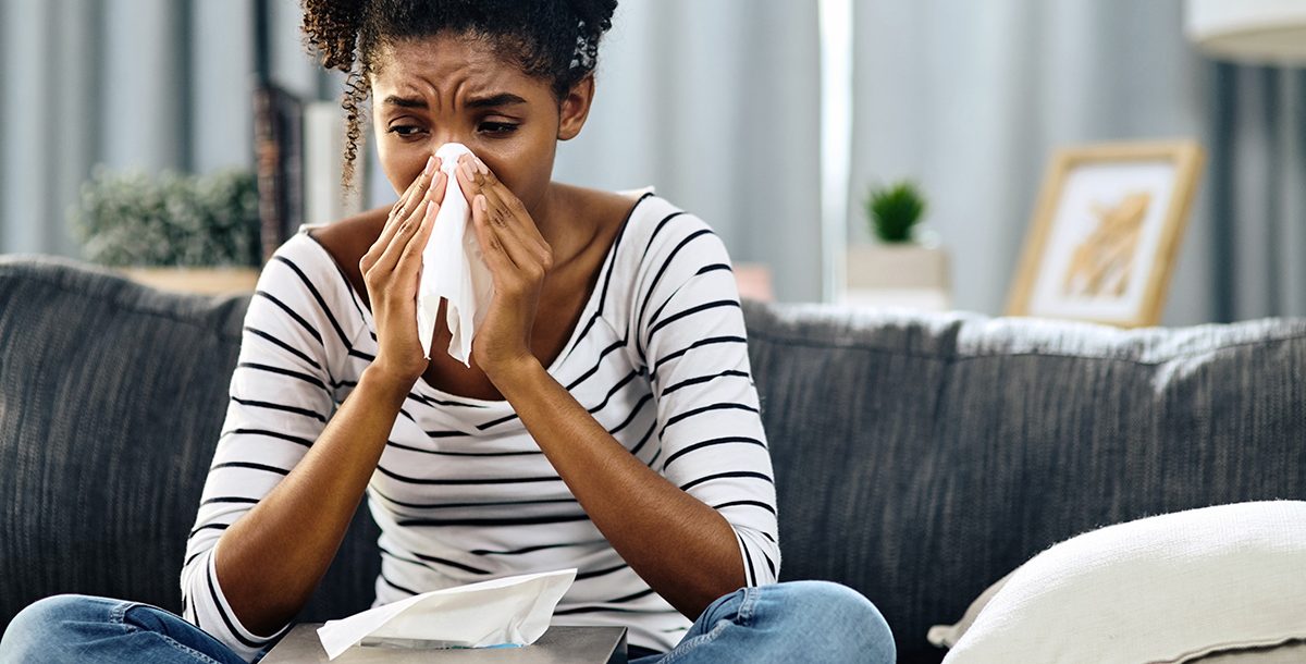 A woman experiencing hay fever symptoms.