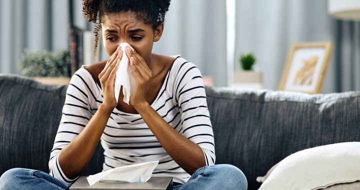 A woman experiencing hay fever symptoms.