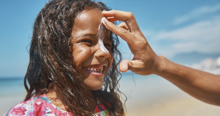 A child putting sunscreen on.