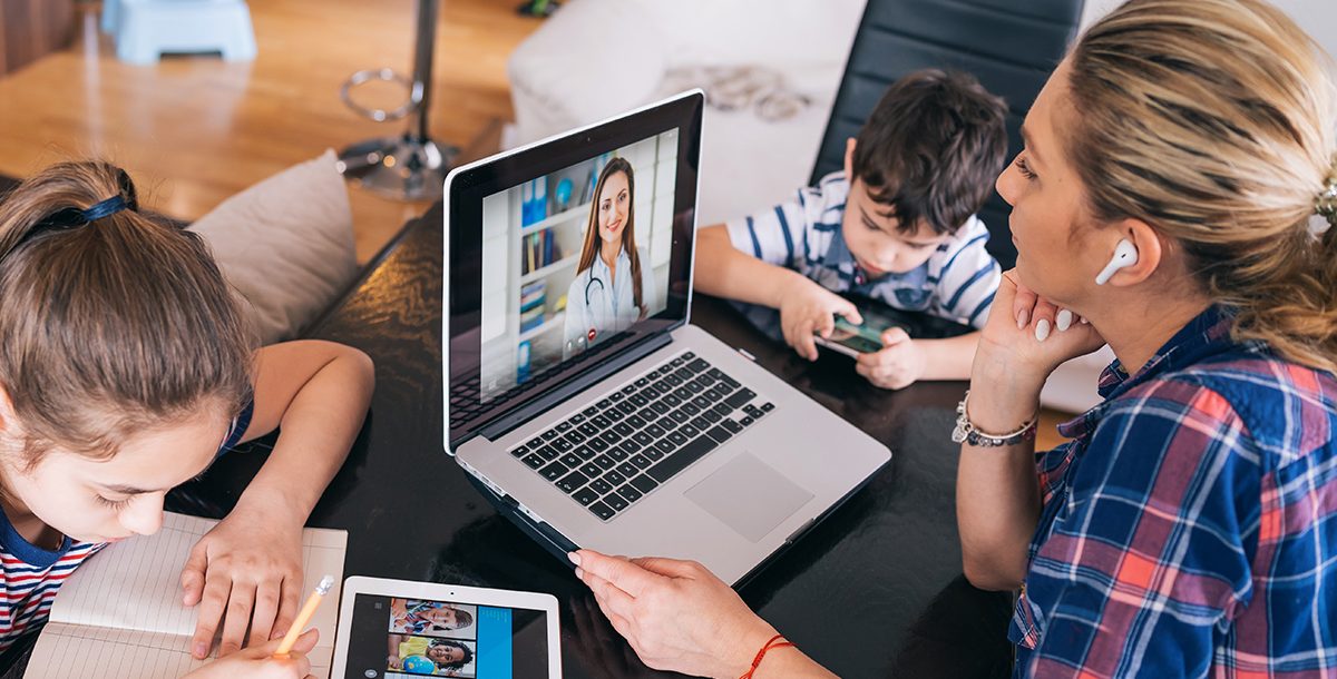 A mom having a video visit with her provider at home.