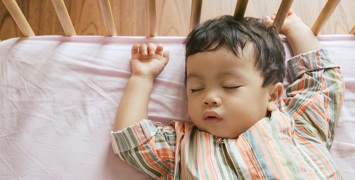 A baby sleeping in a crib.