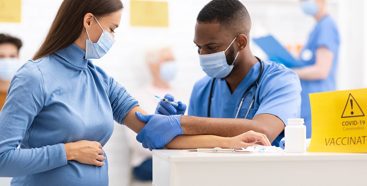 A pregnant woman getting vaccinated for COVID-19.