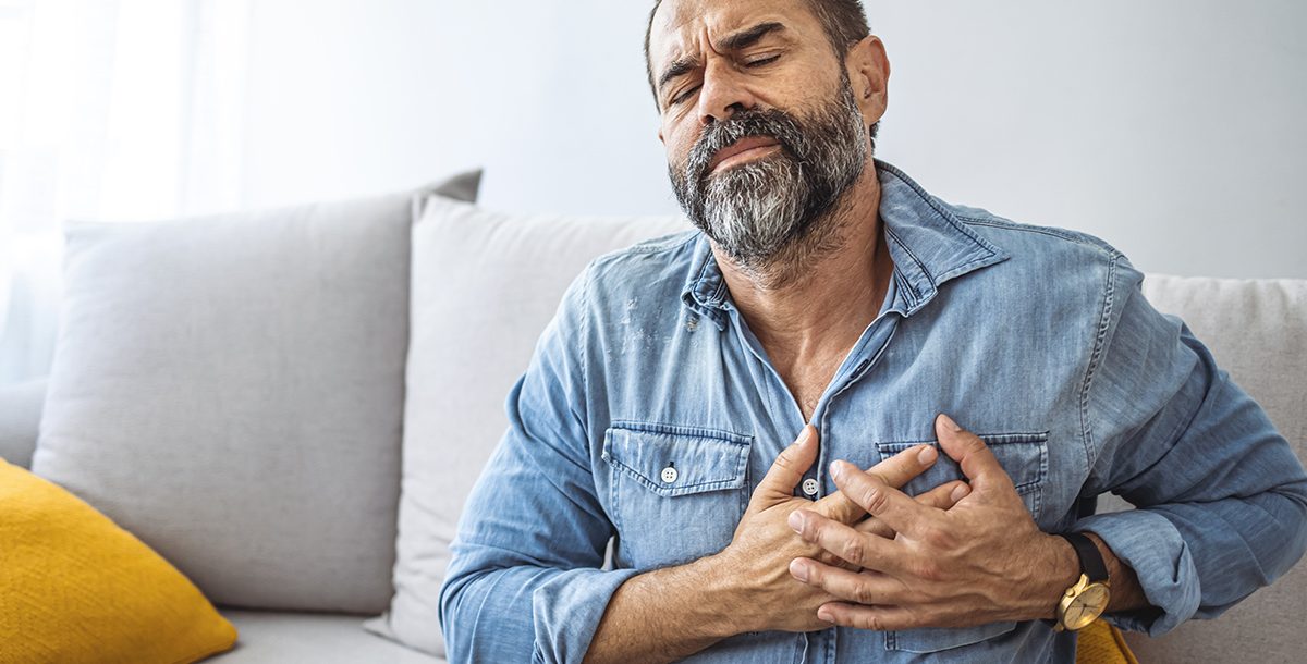 A man holding his heart.