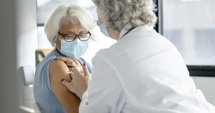 A woman getting her flu and COVID-19 vaccines.