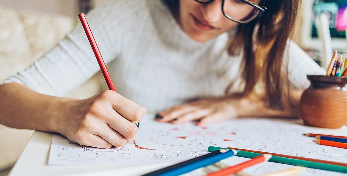 A woman taking a sketching break during the day.