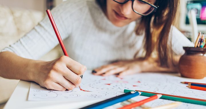 A woman taking a sketching break during the day.