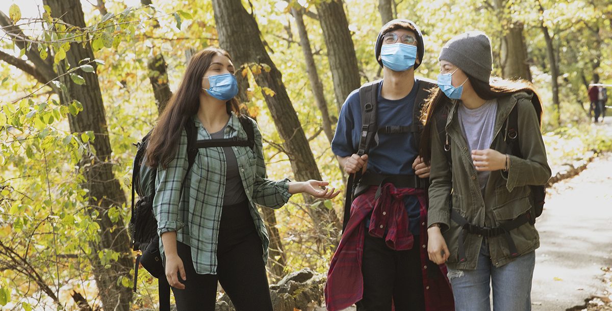 friends wearing face masks around each other