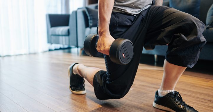 A man doing lunges at home.