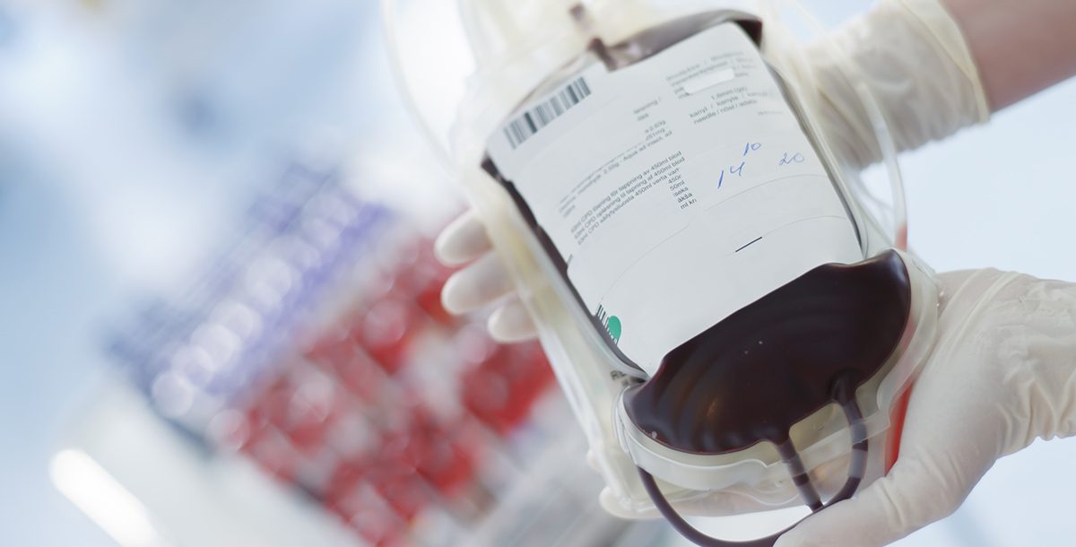 Photo of Nurse holding blood transfusion bag.