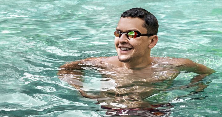 A person wearing goggles in the pool.