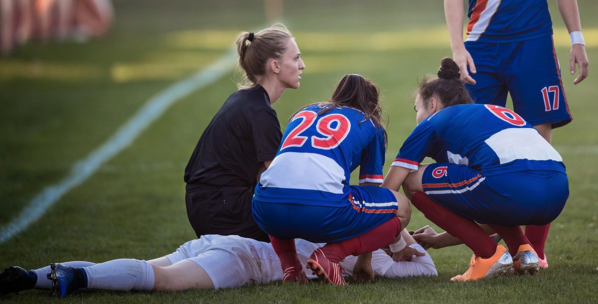 A student soccer player suffering from an injury.